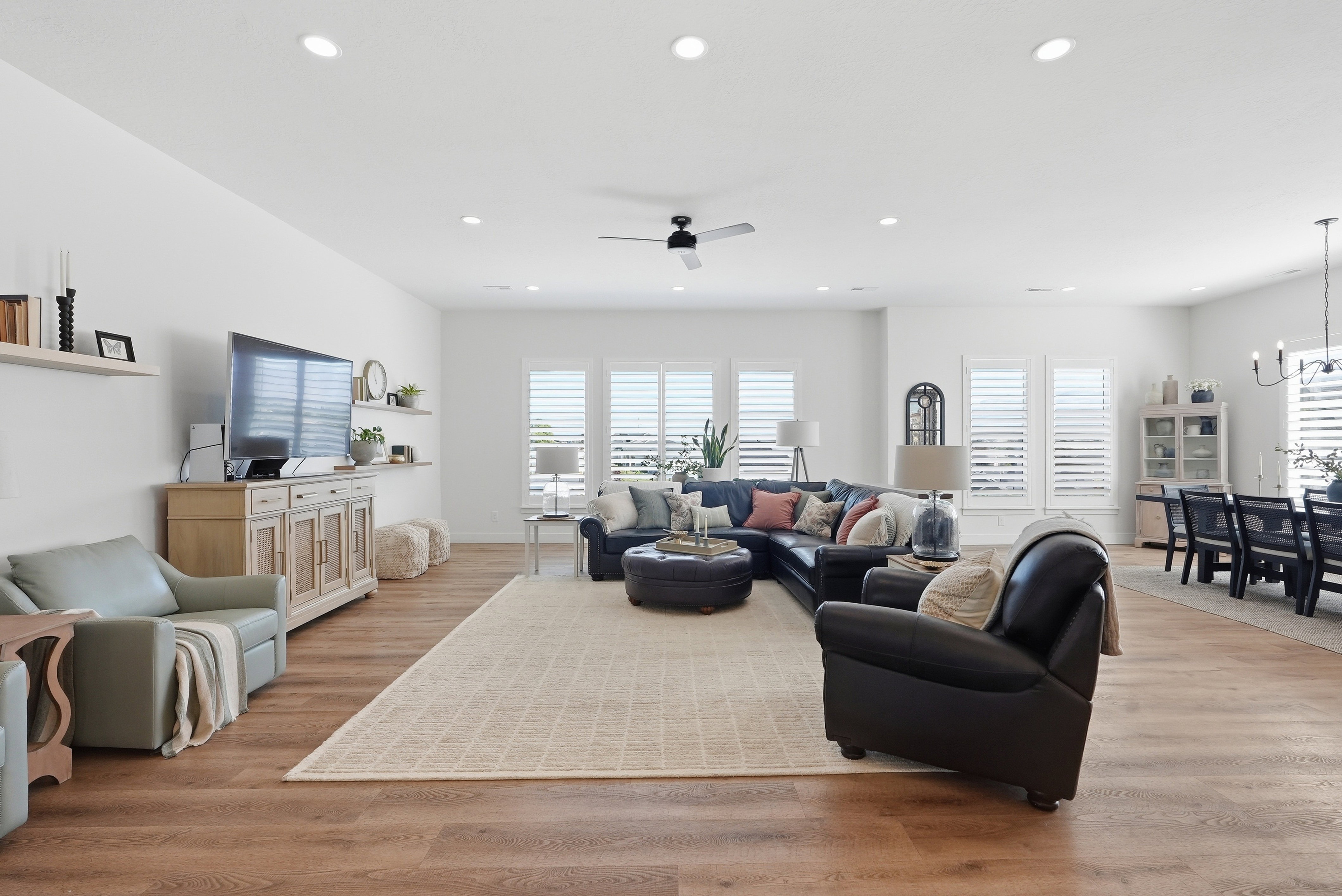 Spacious living area featuring LVP  flooring, recessed lighting, and a ceiling fan