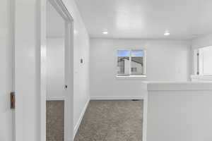 Bright interior space featuring light-colored walls and recessed lighting