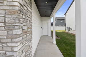 Covered entry with stone veneer and horizontal siding