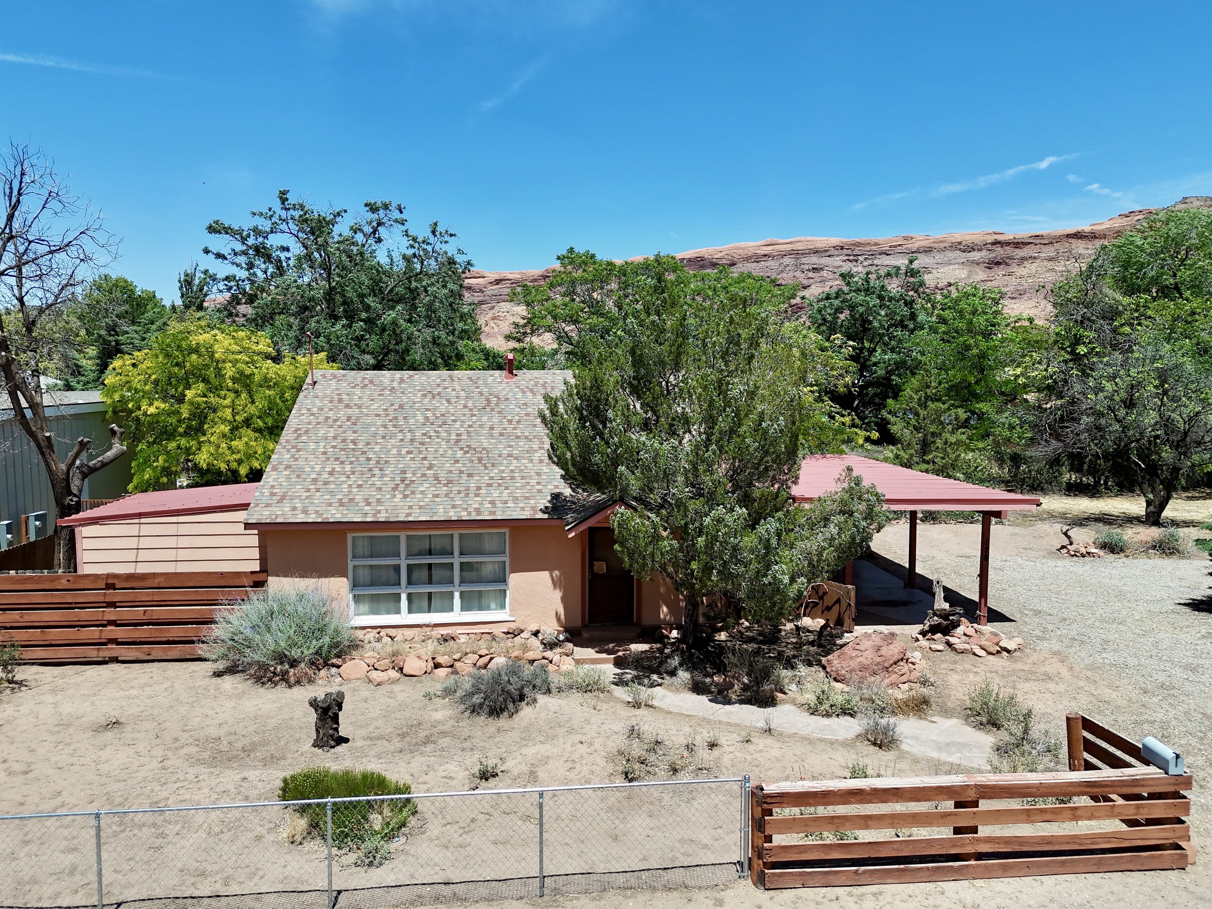 Single-story residence featuring a shingle roof and a covered porch