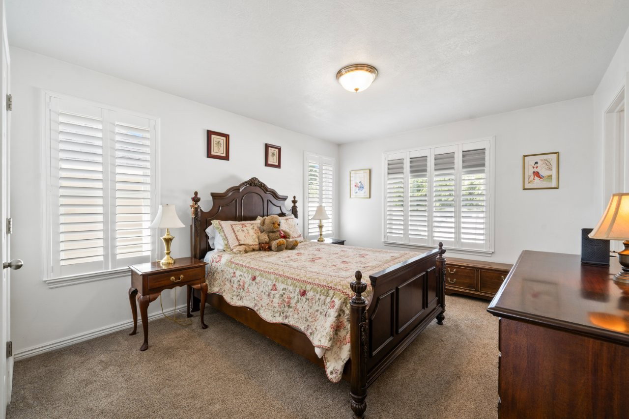 Bedroom featuring dark carpet and baseboards