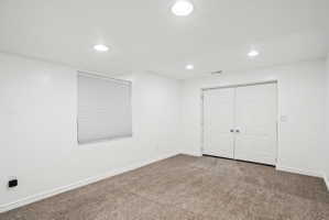 Unfurnished bedroom with carpet, recessed lighting, and a closet