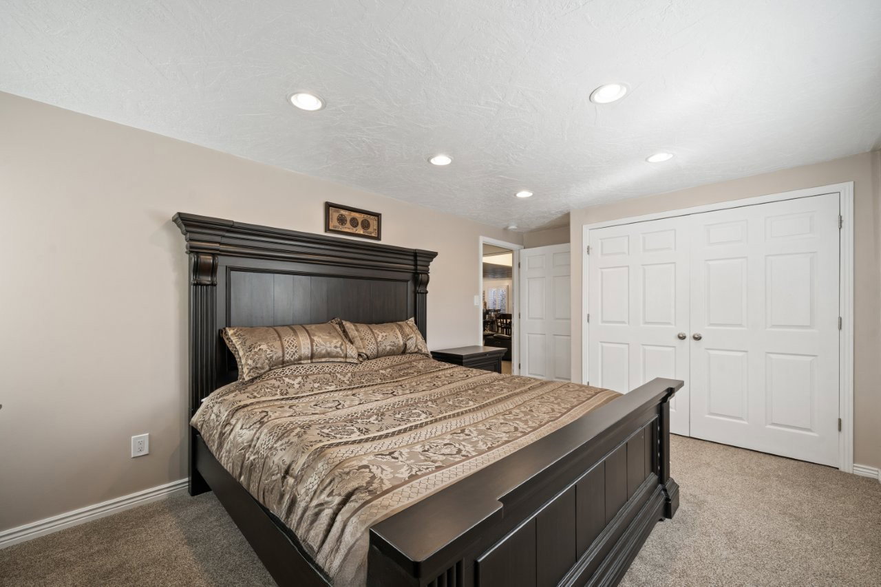 Bedroom featuring recessed lighting, light colored carpet, a closet, and a textured ceiling