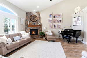 Spacious living area featuring a vaulted ceiling and wood-finish flooring