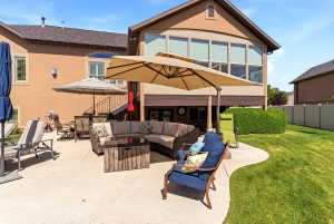 Expansive concrete patio with a curved edge and integrated lawn space