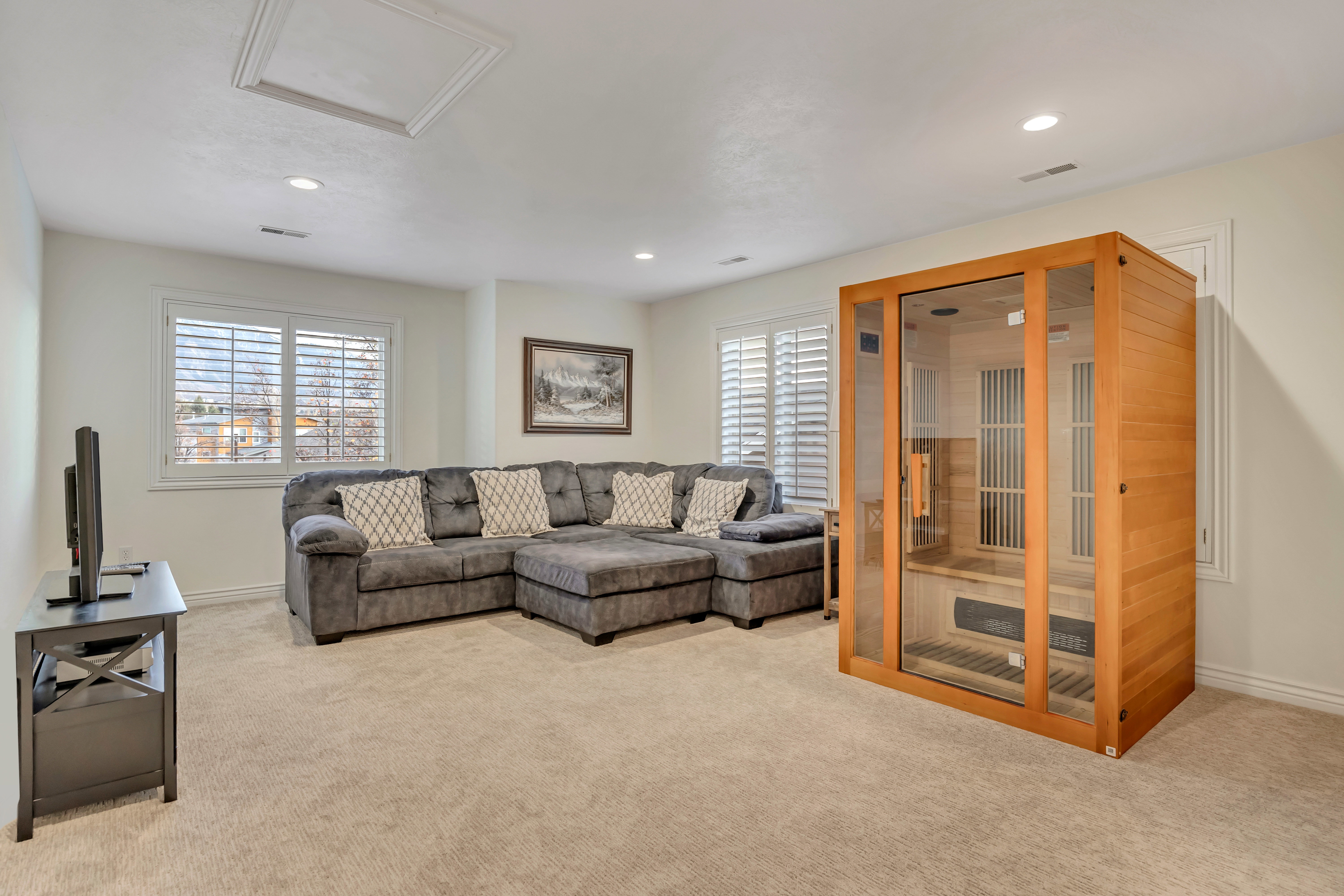 Carpeted bonus room with recessed lighting and crown molding