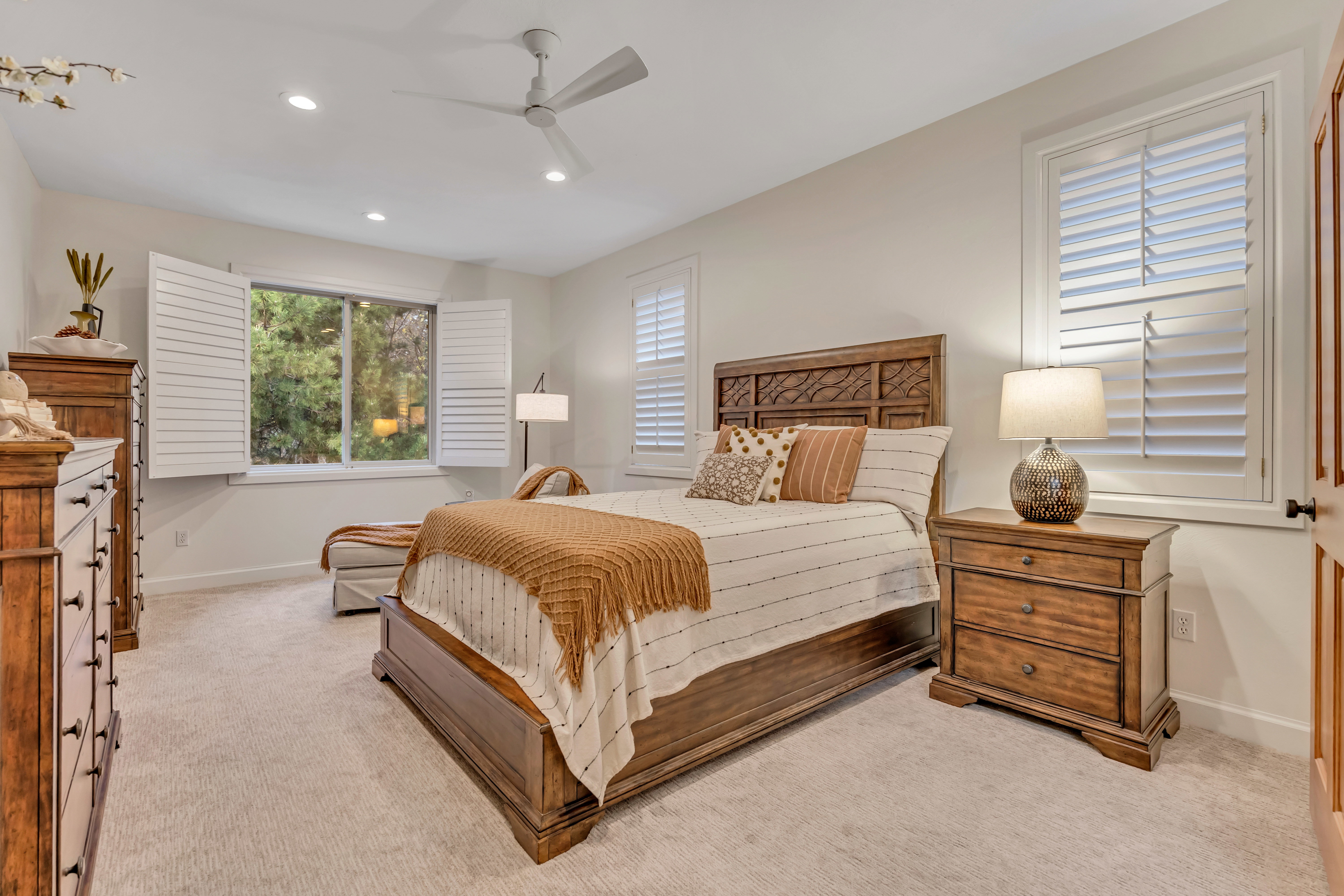 Neutral tone wall paint, recessed lighting, and a contemporary ceiling fan