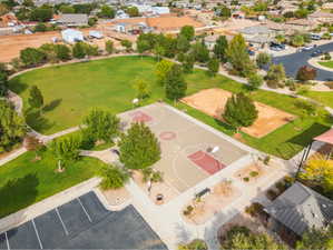 Community park featuring a basketball court, sand volleyball court, and expansive green spaces