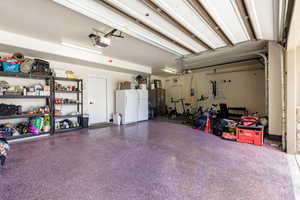 Spacious garage with an epoxy floor finish and an automatic garage door opener