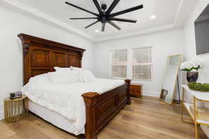 Spacious room featuring wood-finish flooring, white walls, and a recessed ceiling