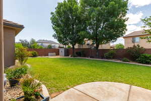 Expansive backyard with a concrete patio