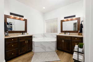 Corner soaking tub with marble-look tile surround