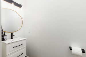 White vanity with two drawers featuring black pulls