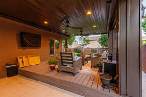 Expansive covered patio featuring wood-finish ceiling, recessed lighting, and ceiling fans