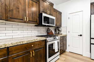 Wood-finish flooring complementing rich, dark wood cabinetry