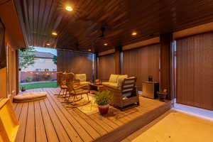 Covered patio featuring wood-finish decking, recessed lighting, and a ceiling fan