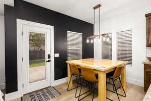 Dining area featuring wood-finish flooring and a full-light exterior door