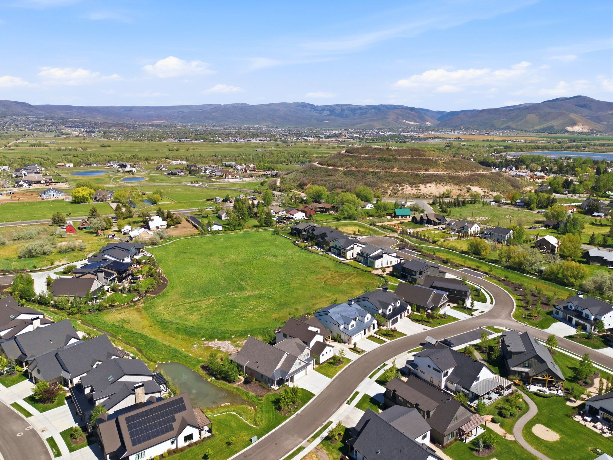 Aerial perspective showcasing a developed residential neighborhood with paved streets