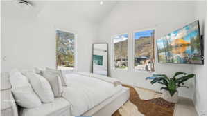 Vaulted white ceilings featuring a ceiling fan