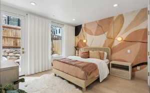 Accent wall with abstract design, two spherical wall sconces, recessed lighting, wood-finish flooring, and a glass-paned door leading to the exterior