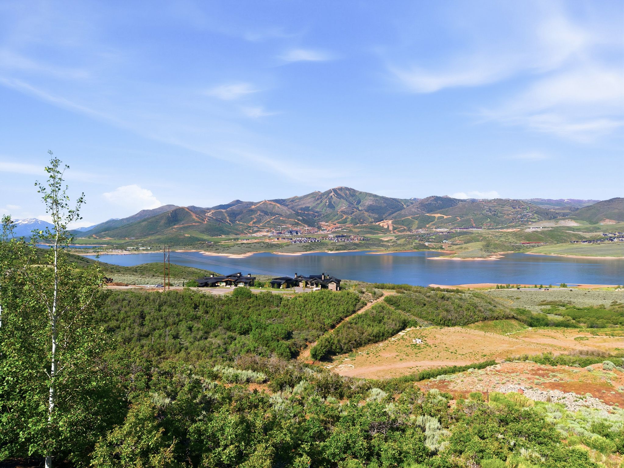Expansive natural landscape featuring a prominent lake and distant mountains