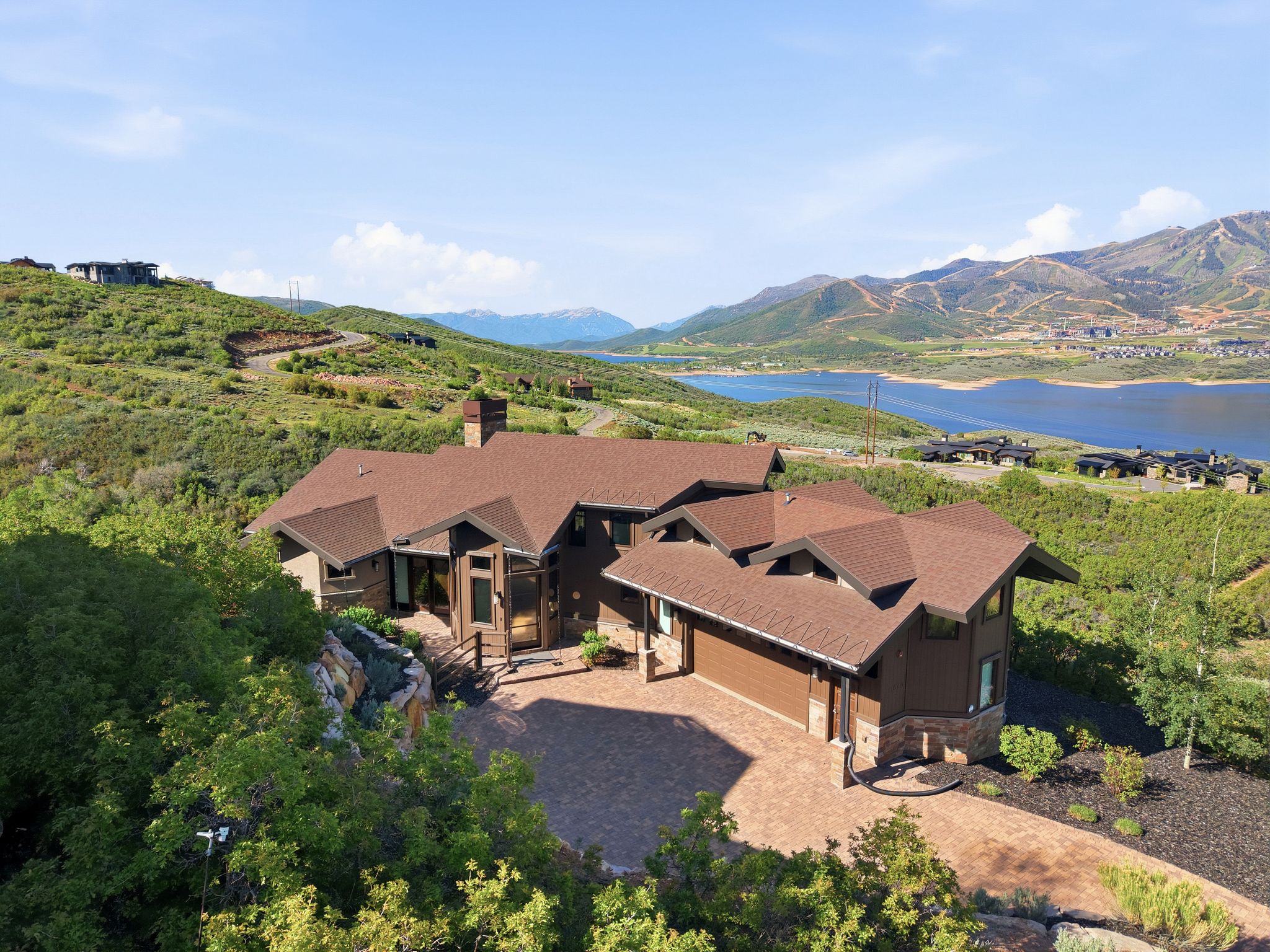 Expansive residence with a multi-gabled roofline and stone accents