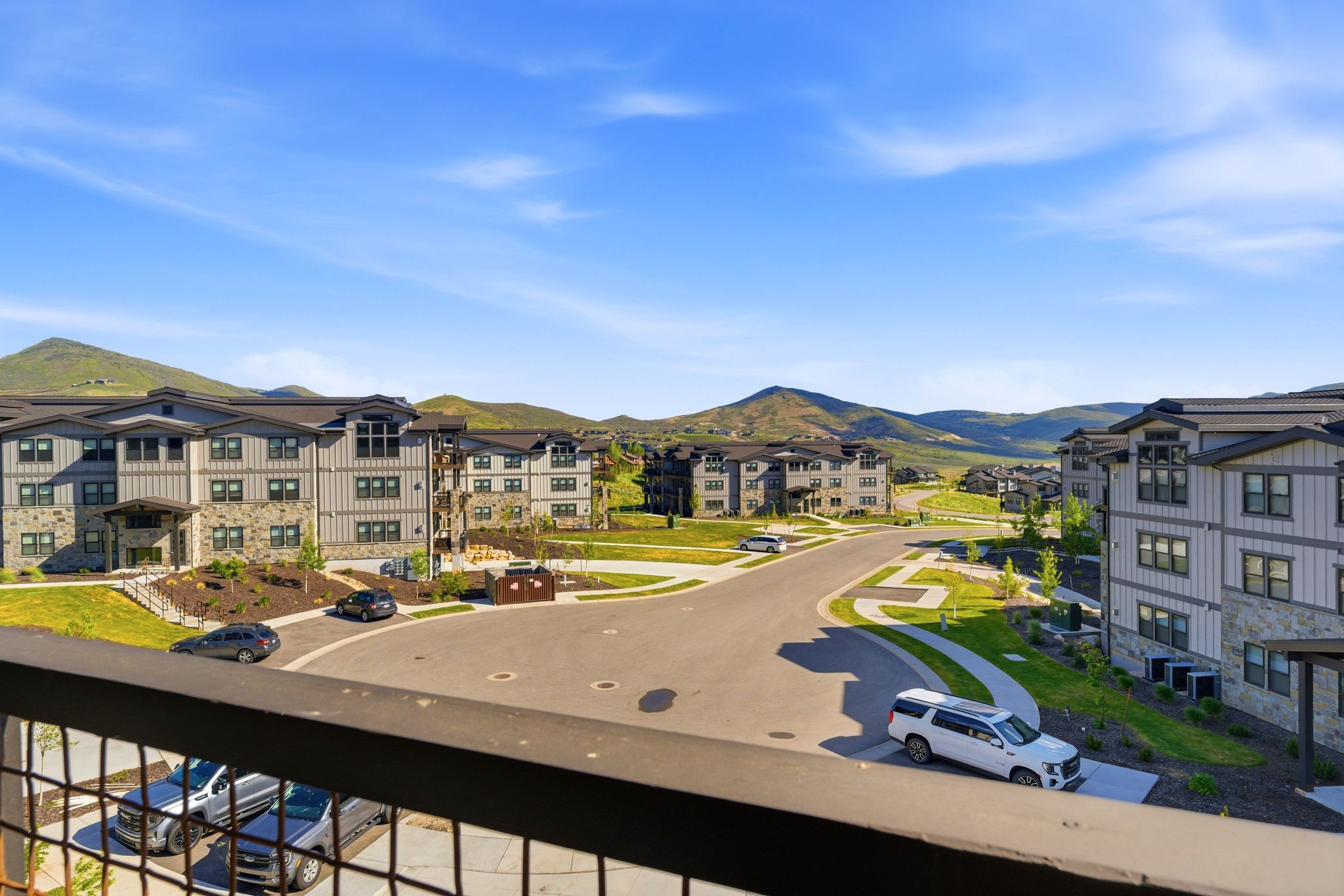 Expansive mountain scenery framing modern multi-story buildings with stone and siding exteriors