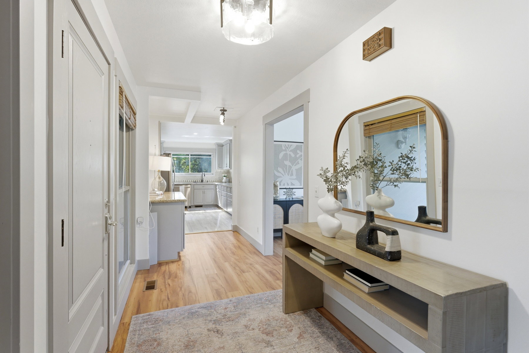 Hallway featuring wood-finish flooring, white walls, and a recessed ceiling light fixture