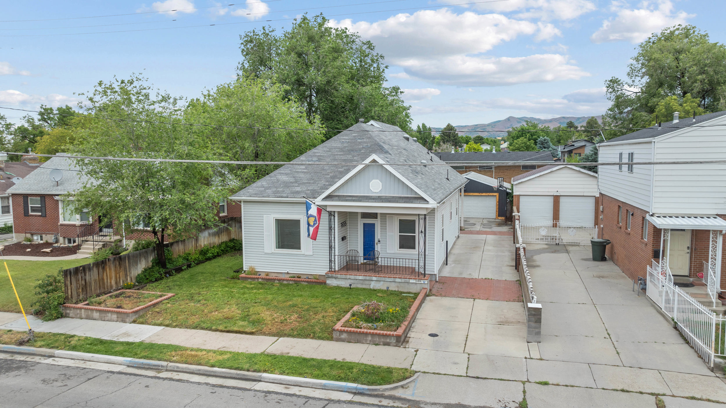 Light gray siding exterior with a contrasting blue entry door