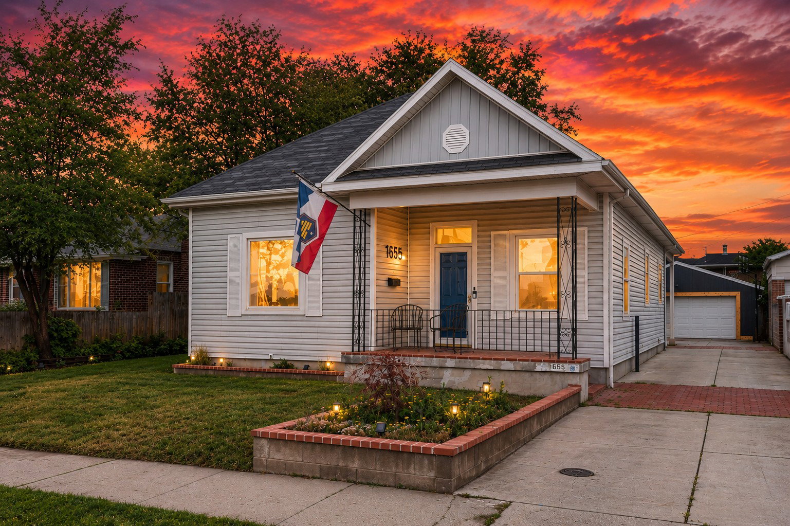 Charming single-story residence featuring light-colored siding, a dark blue entry door, and white window shutters