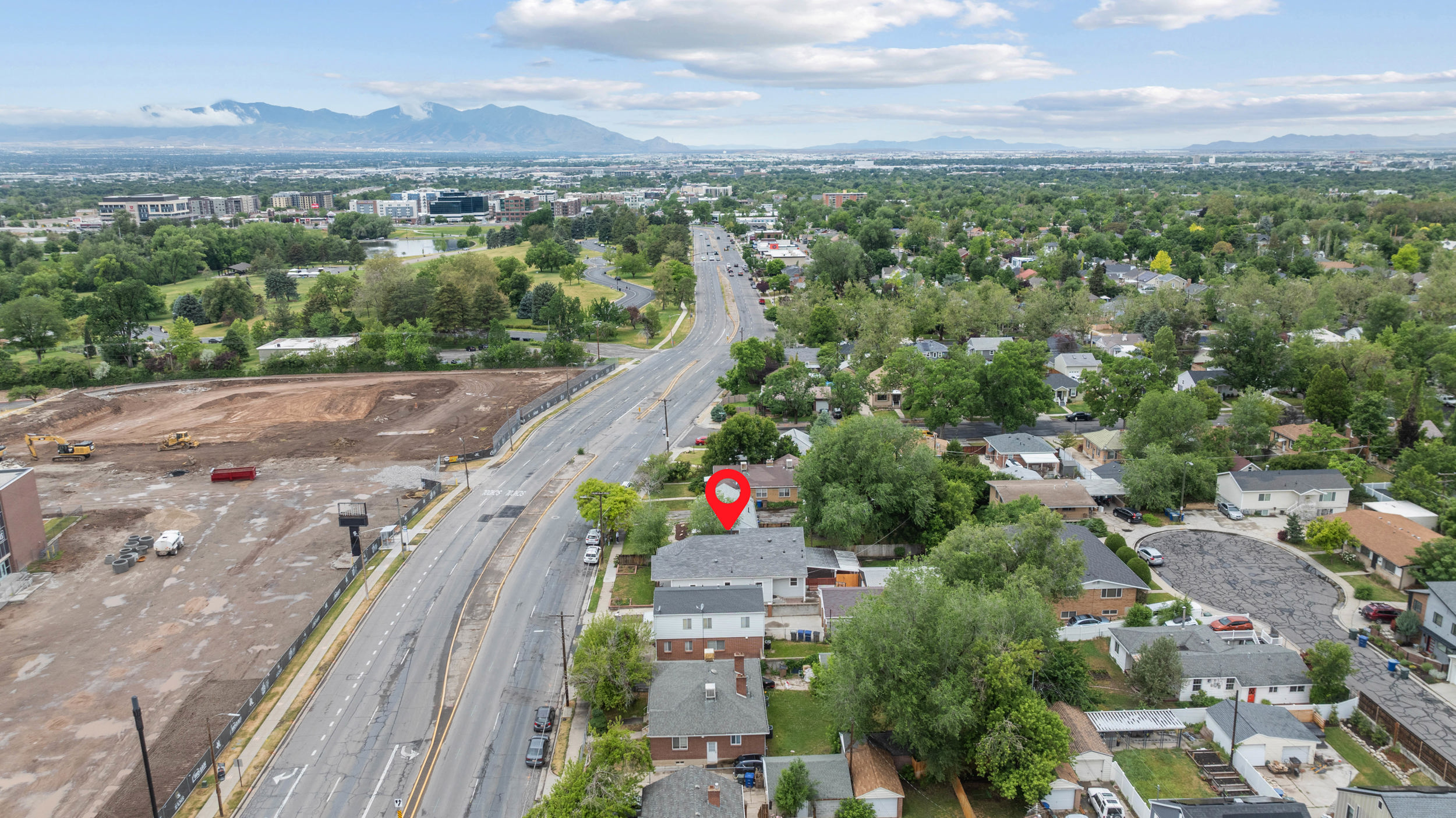 Aerial capture of a residential neighborhood with distant mountains