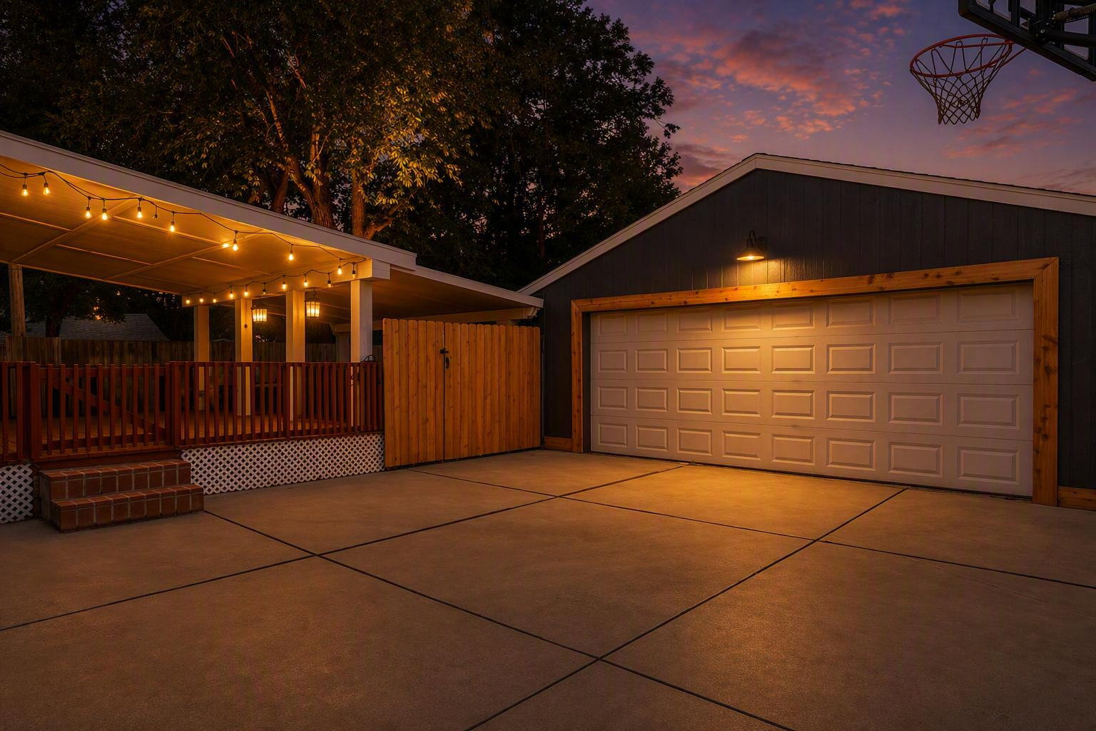 Spacious concrete driveway and attached garage with a decorative wood frame