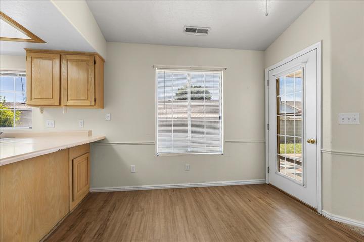 Kitchen area featuring wood-finish flooring, light-toned cabinetry, and a light-toned countertop