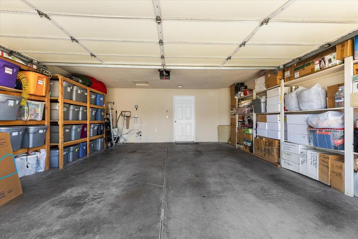 Spacious garage featuring concrete flooring and overhead garage door