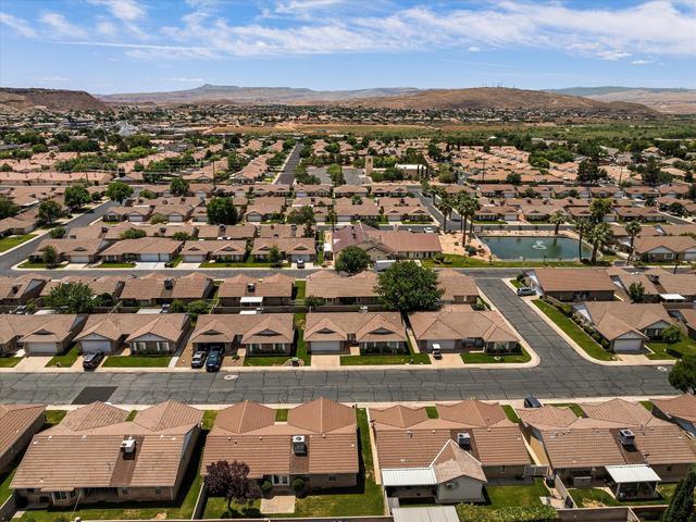 Aerial perspective showcasing a residential community with uniform tile roofs and landscaped yards