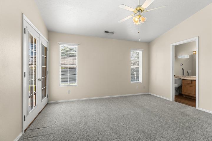 Spacious room with vaulted ceilings and light-colored walls