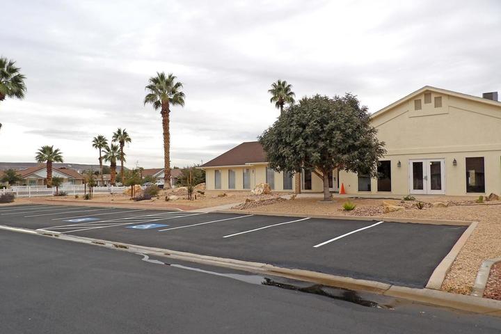 Paved parking lot with white striped spaces and designated accessible parking
