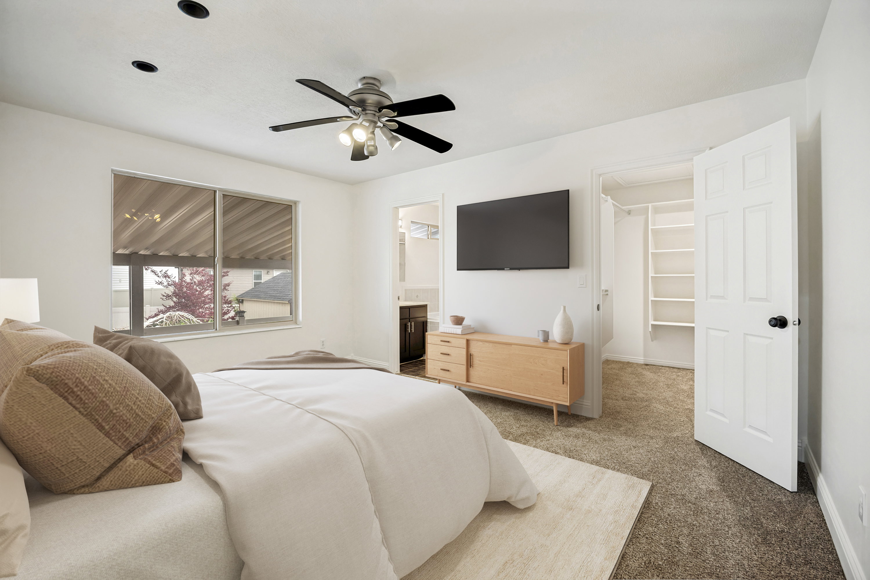 Carpeted bedroom featuring a ceiling fan with integrated lighting, recessed lighting, and a window with blinds