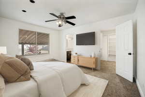 Carpeted bedroom featuring a ceiling fan with integrated lighting, recessed lighting, and a window with blinds