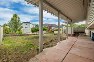 Expansive covered patio featuring a concrete slab and metal support beams