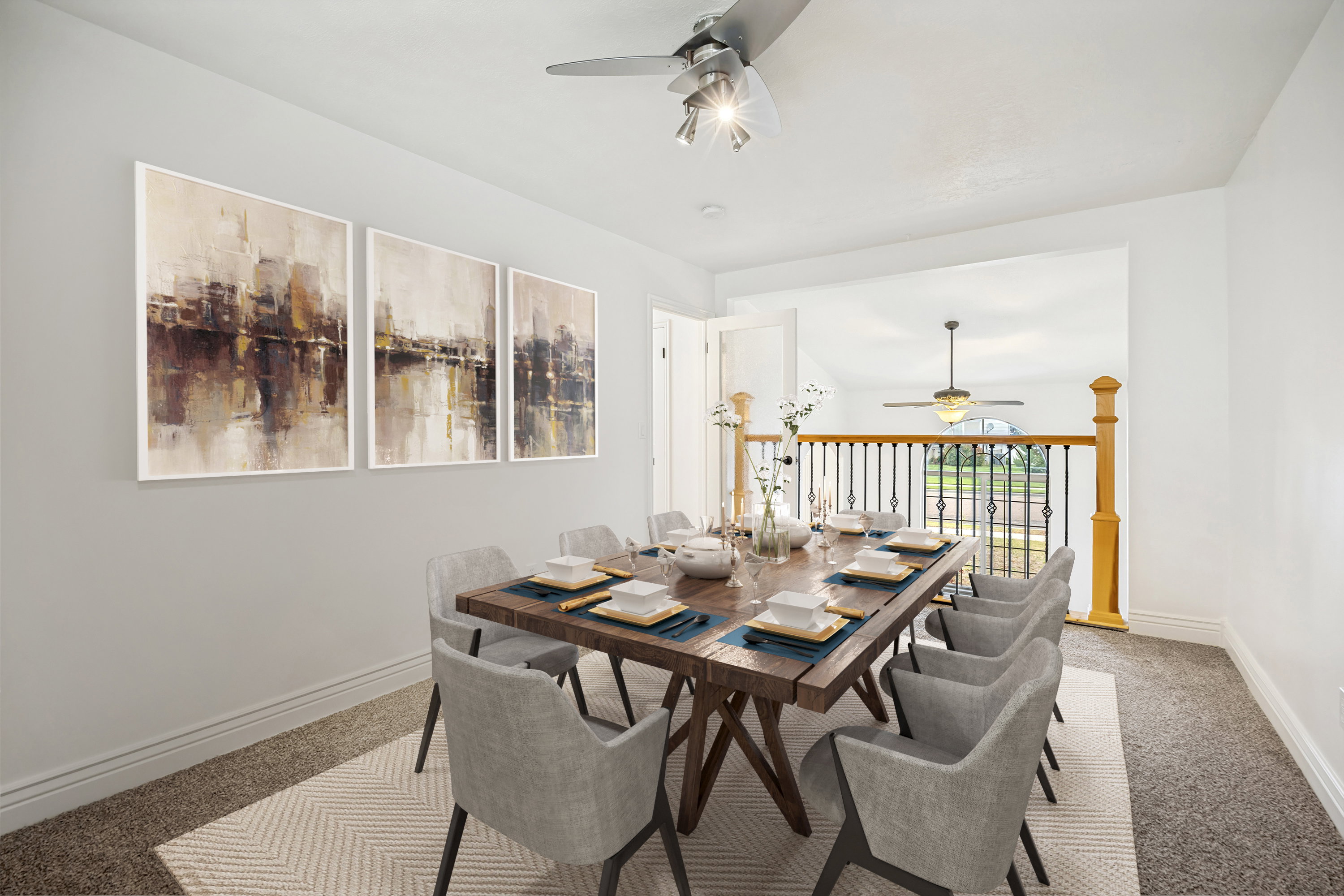 Open-concept dining area featuring a wood-finish dining table and carpeted flooring