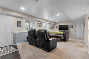 Spacious lower-level room featuring recessed lighting, a neutral color palette, and multiple windows with white plantation shutters