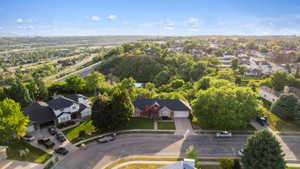 Suburban residential setting featuring mature landscaping and varied architectural styles