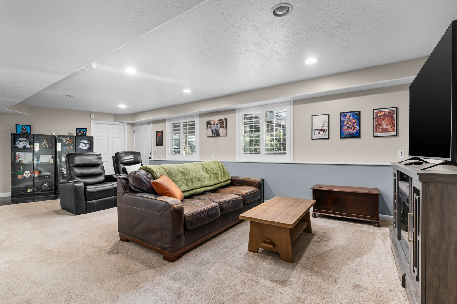 Expansive recreation room featuring recessed lighting, a neutral carpet, and plantation shutters