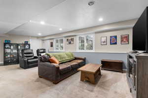 Expansive recreation room featuring recessed lighting, a neutral carpet, and plantation shutters