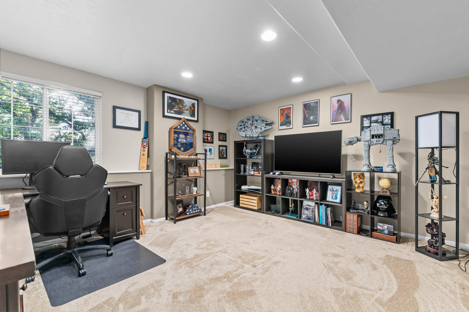 Carpeted interior space featuring a window with blinds, recessed lighting