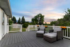 Spacious outdoor deck featuring composite decking, white railing, and a secure gate