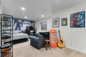 Carpeted interior space featuring recessed lighting, a window with horizontal blinds