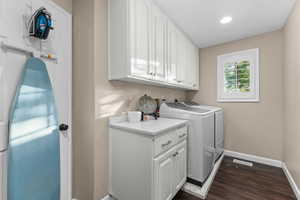 Utility space featuring white cabinetry, a white countertop, and dark wood-finish flooring
