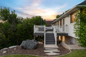 Multi-level exterior deck featuring white railings and grey composite decking